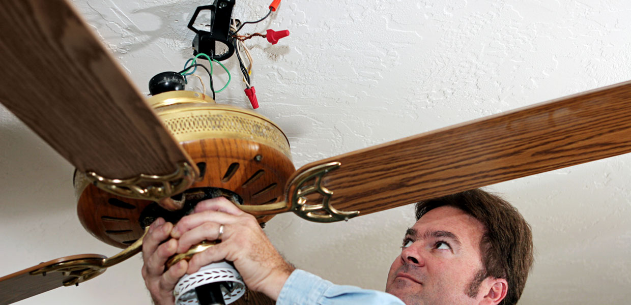 electrician installing a ceiling fan